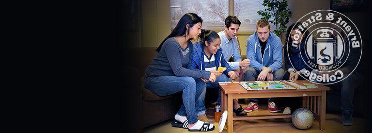 Students playing a board game at the dorms